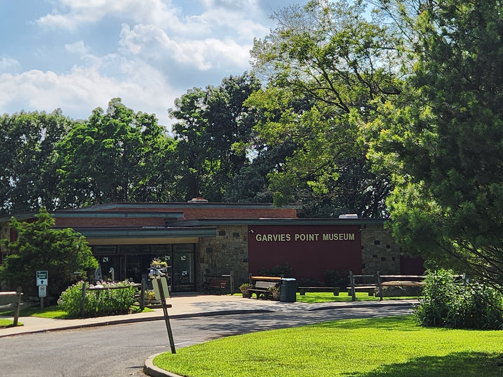 Garvies Point Museum building exterior with dark red sign and landscaped entrance