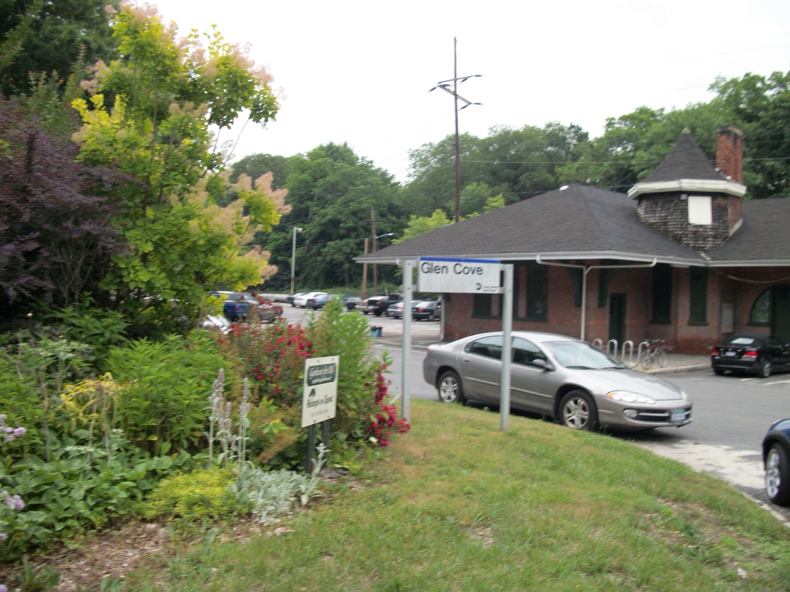 Glen Cove LIRR station building beside a green