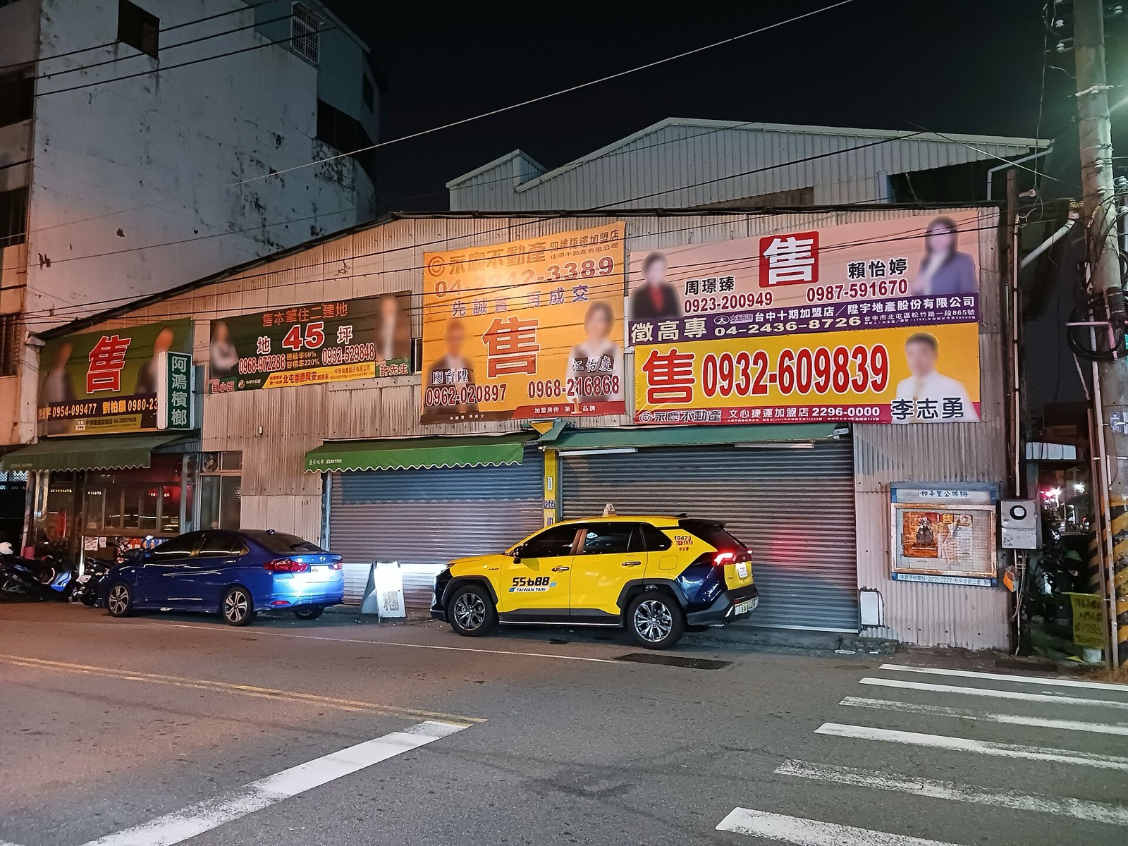 Five different real estate company 'for sale' signs in front of one house