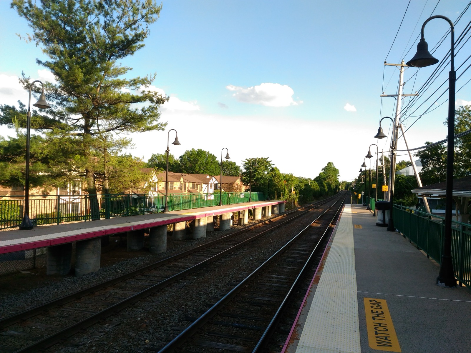 LIRR platform and tracks at Roslyn station with a row of lampposts
